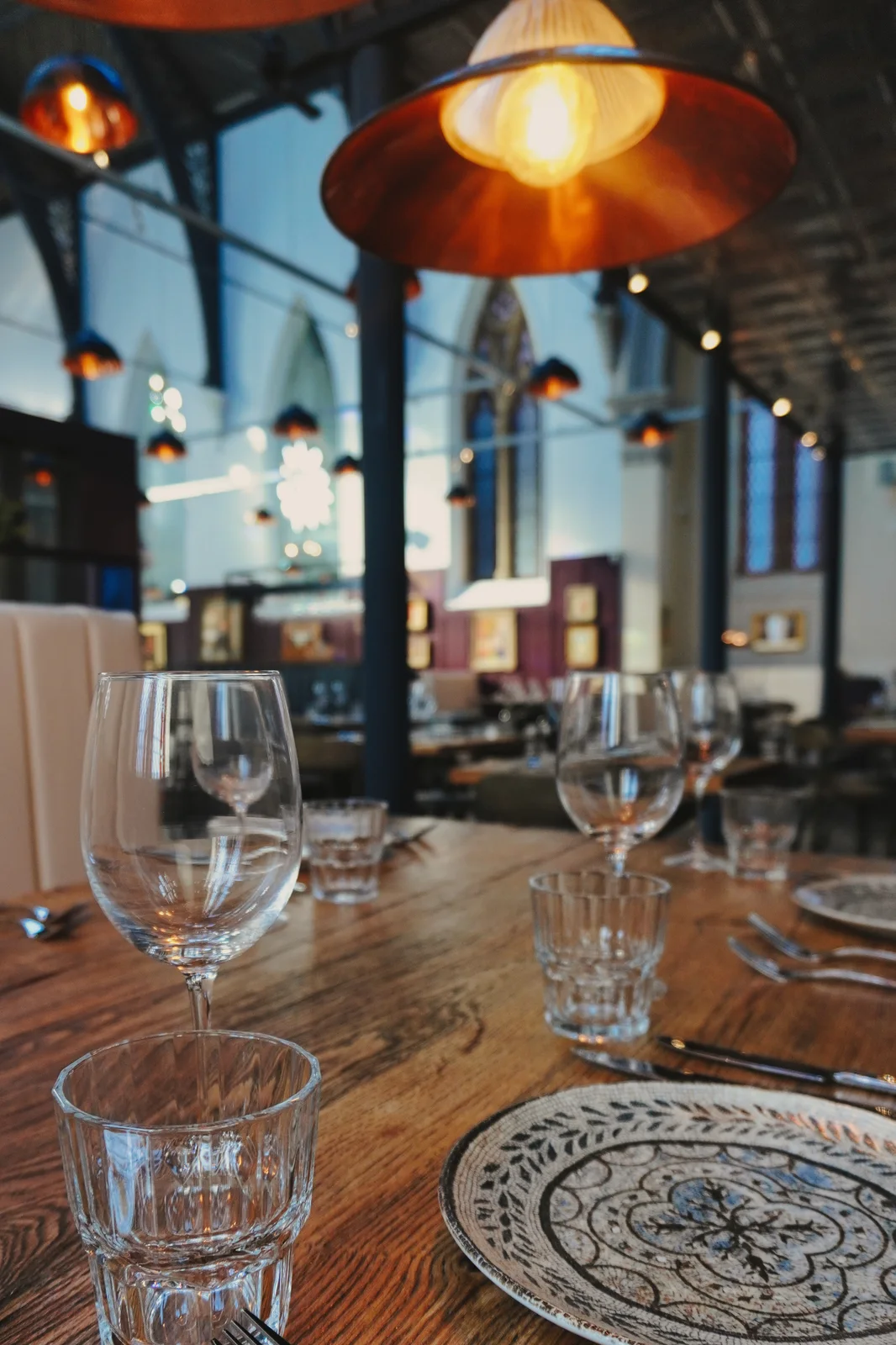 Patterned plates and glassware on a dining table