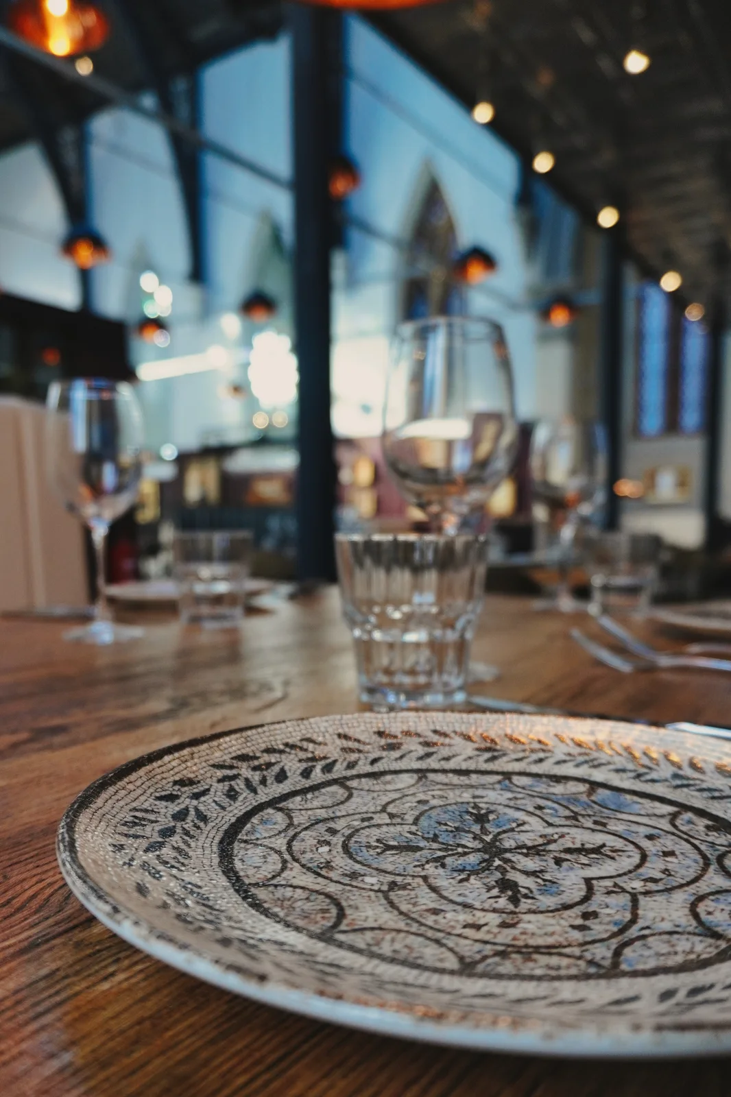 Patterned plates and glassware on a dining table