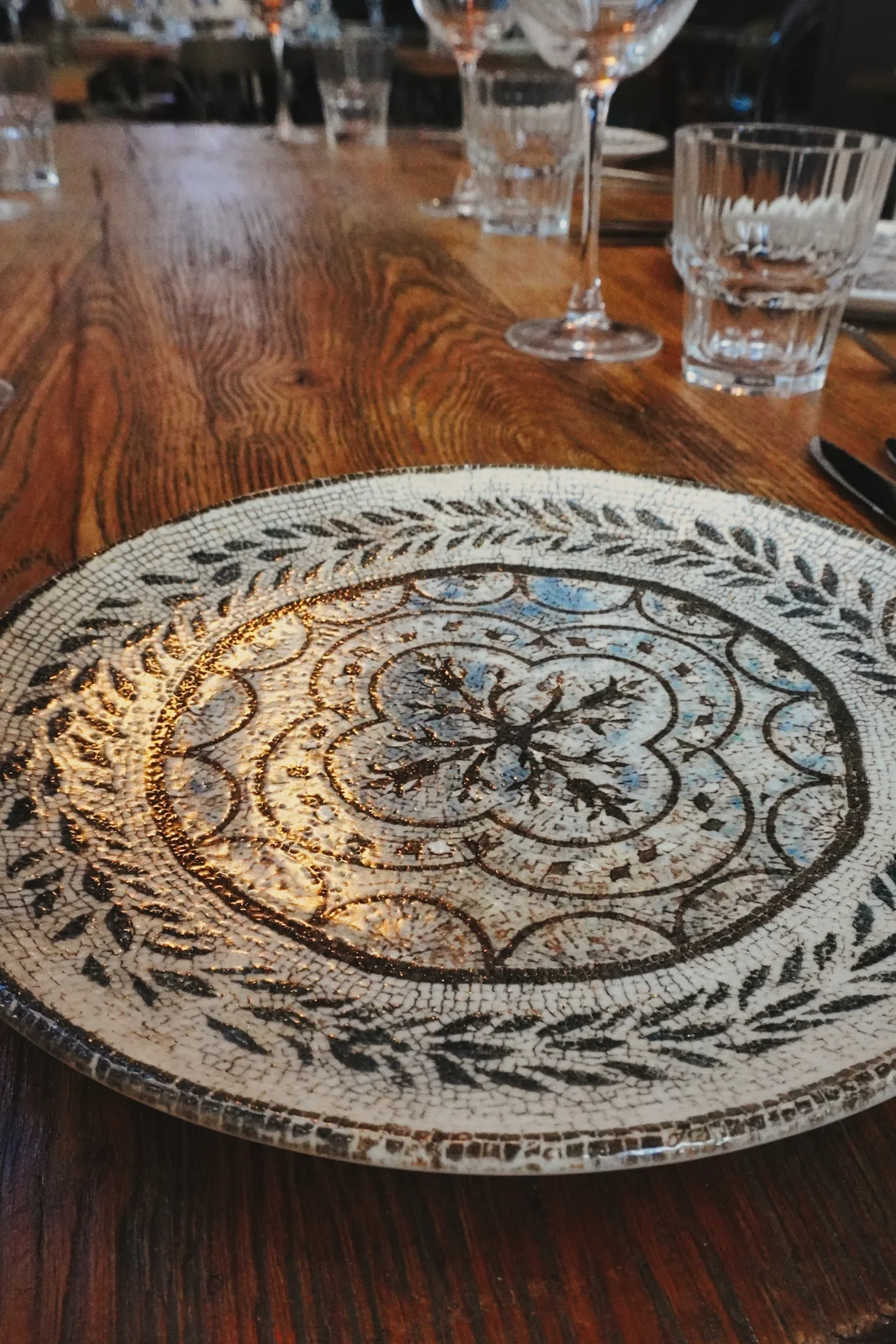 Patterned plates and glassware on a dining table