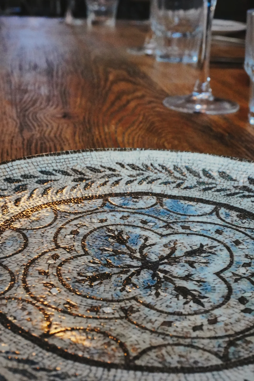 Patterned plates and glassware on a dining table