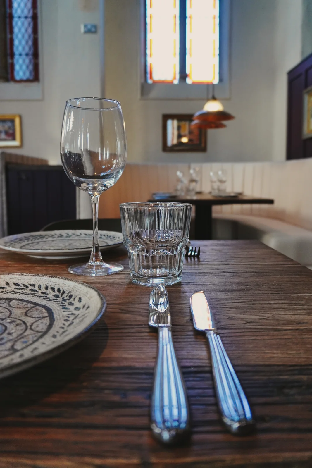 Cream dining booths beneath tall church windows