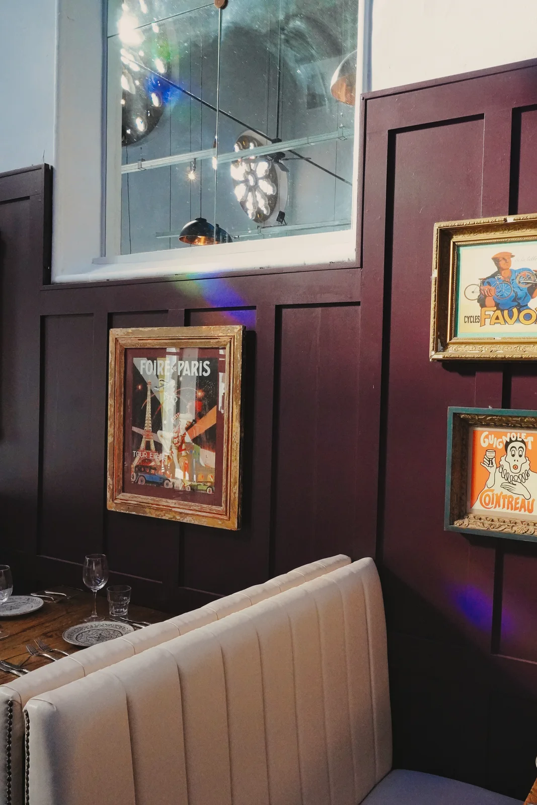 Framed artwork and pendant lighting in the dining room