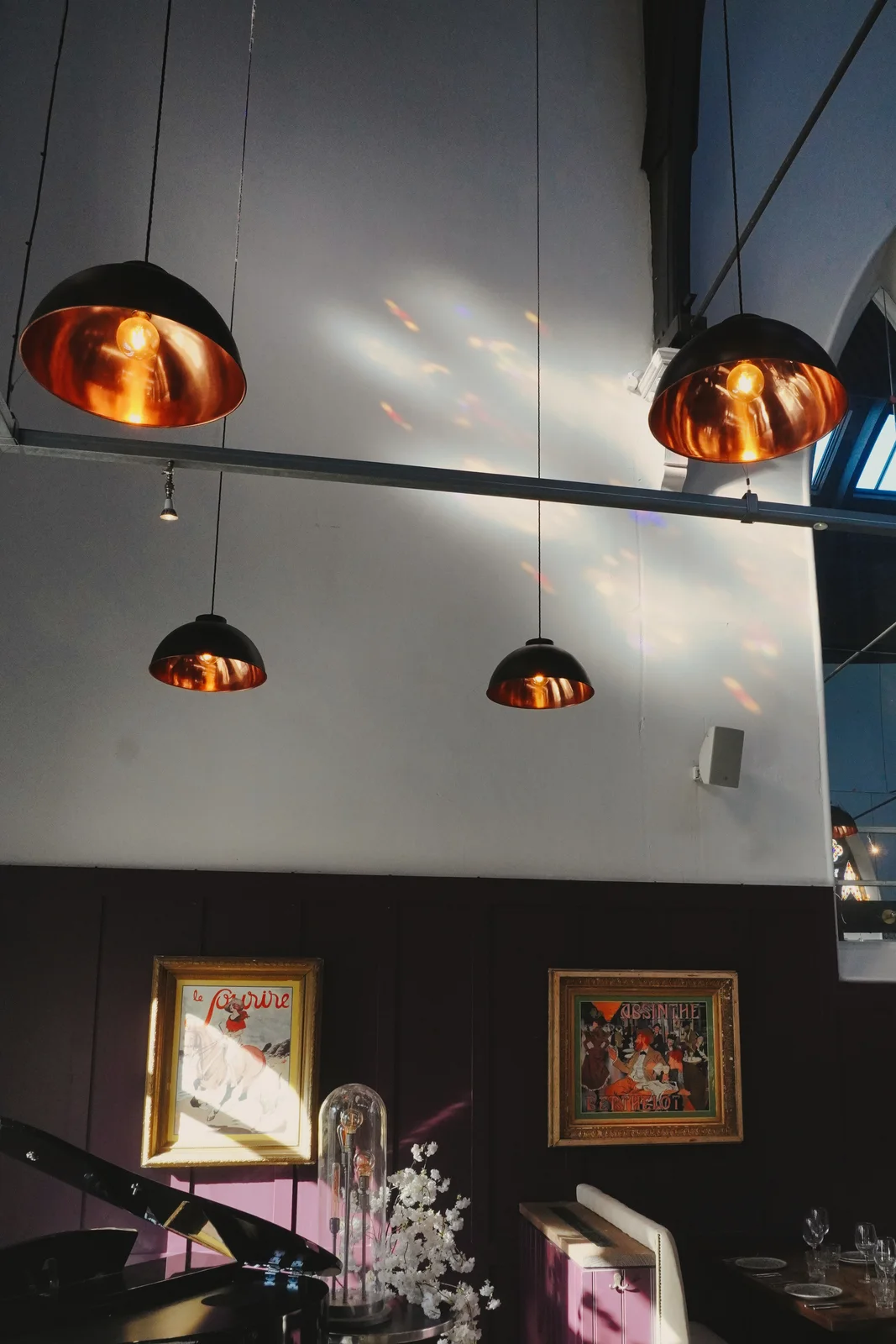Framed artwork and pendant lighting in the dining room