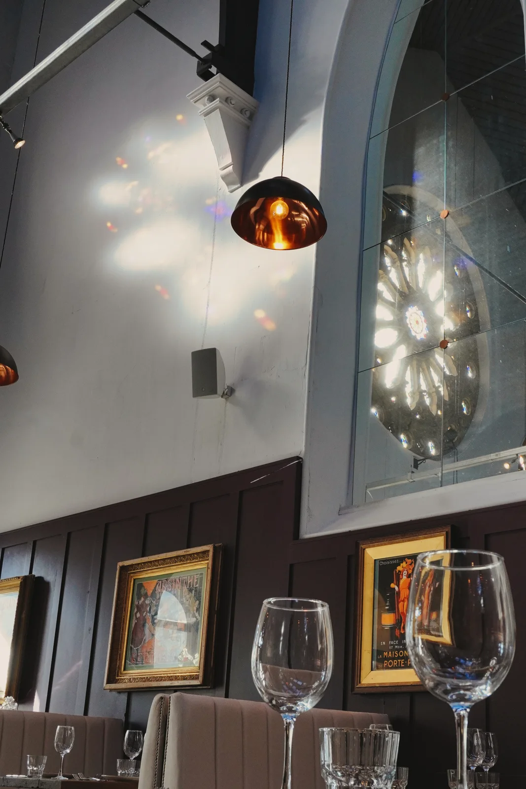 Framed artwork and pendant lighting in the dining room