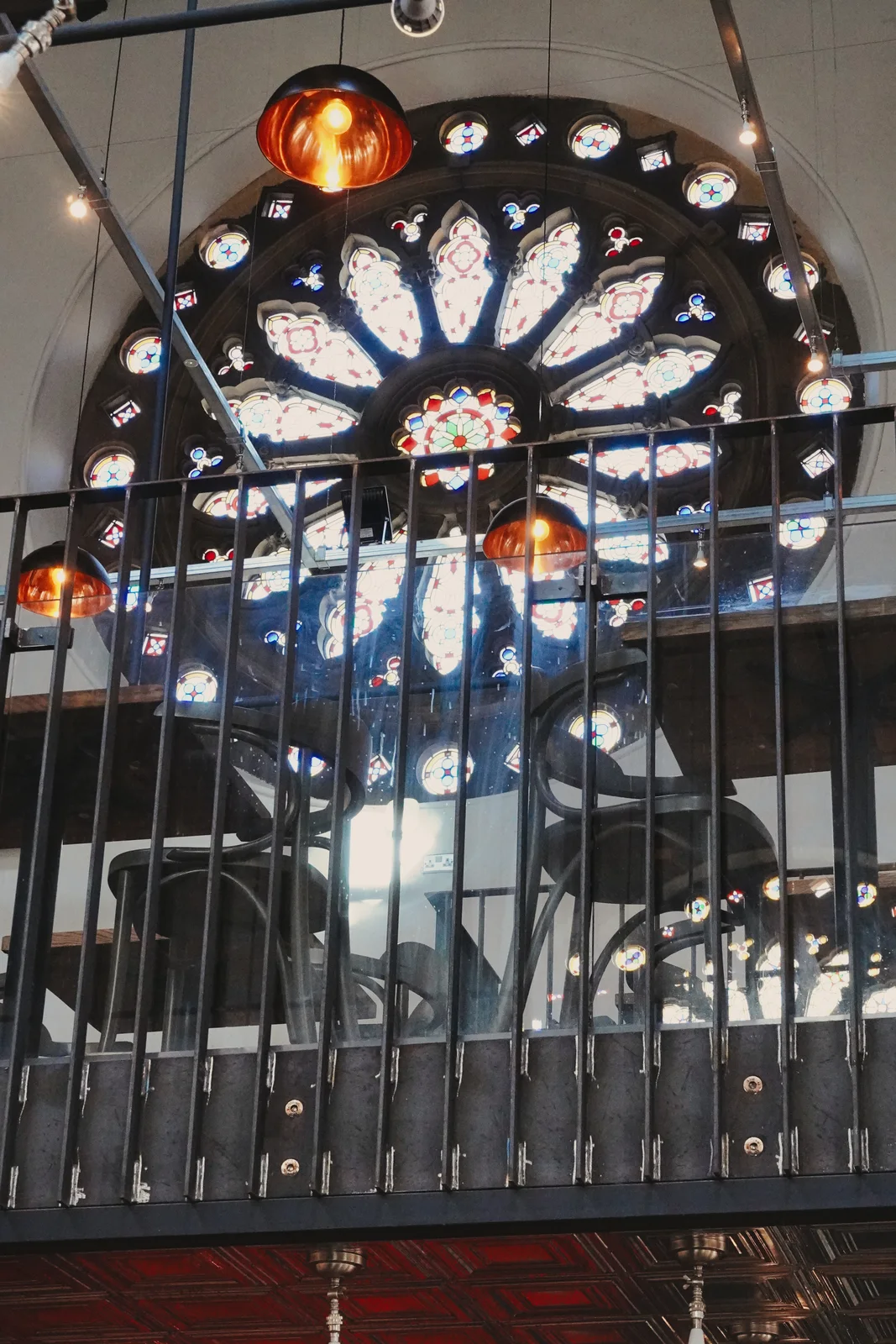 Stained-glass details seen through the gallery railing