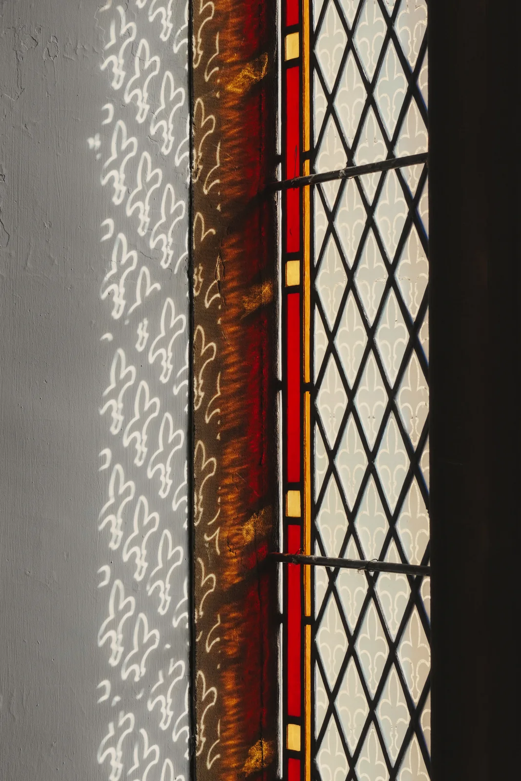 Sunlight through a leaded stained-glass window