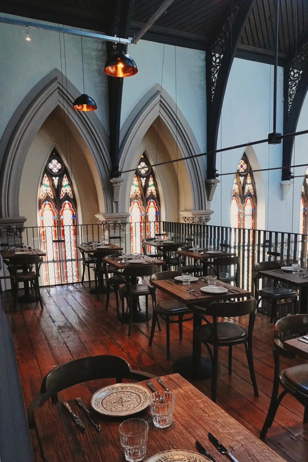 Upstairs dining tables beneath the church arches