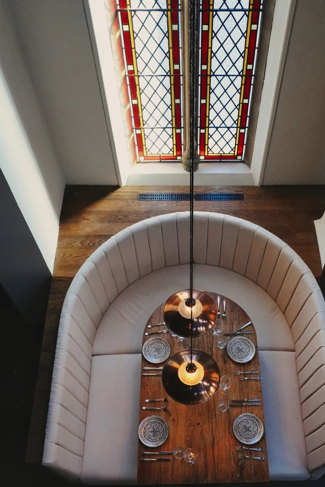 A curved dining booth viewed from the gallery above