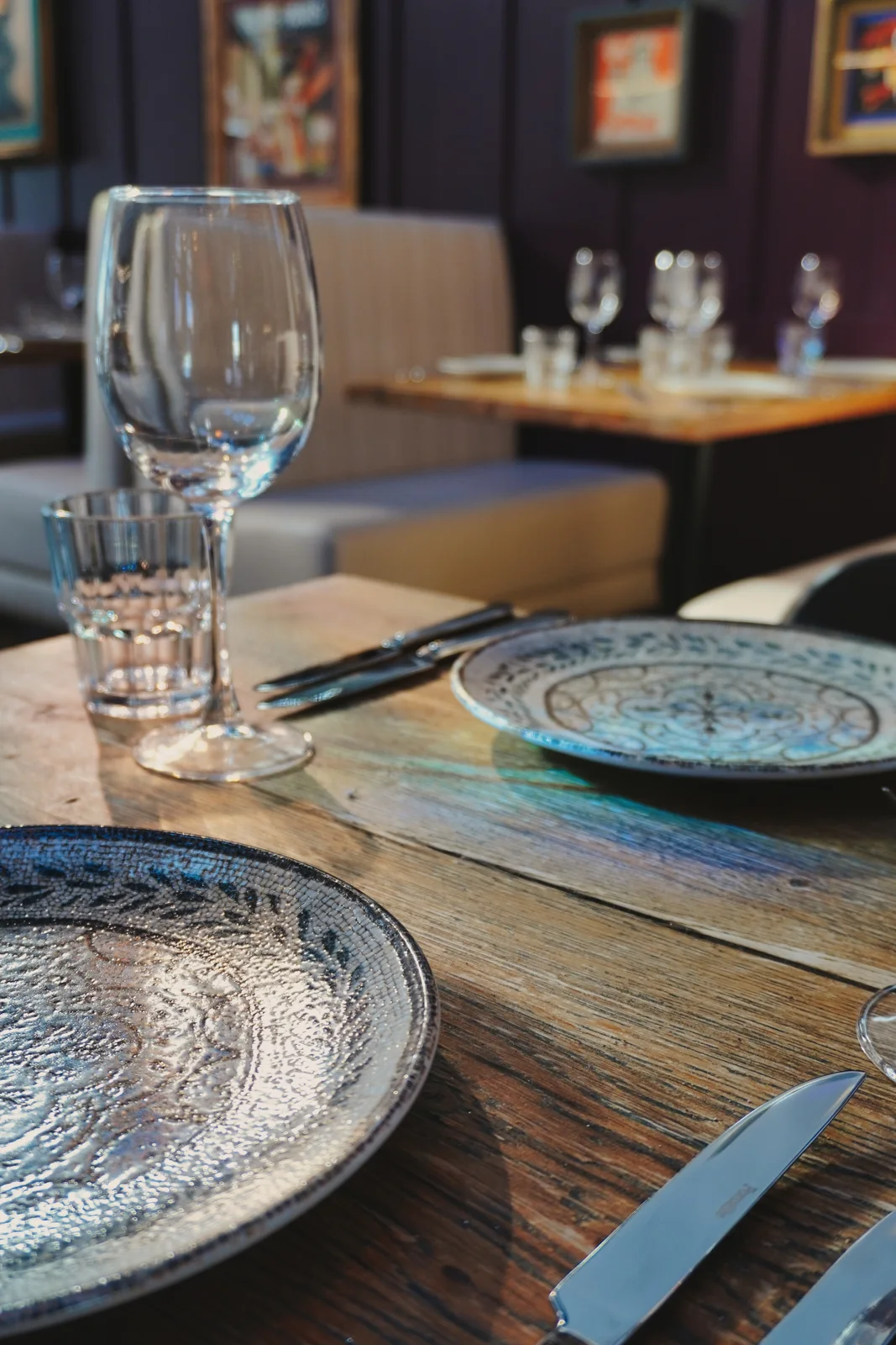 Patterned crockery arranged on a wooden dining table