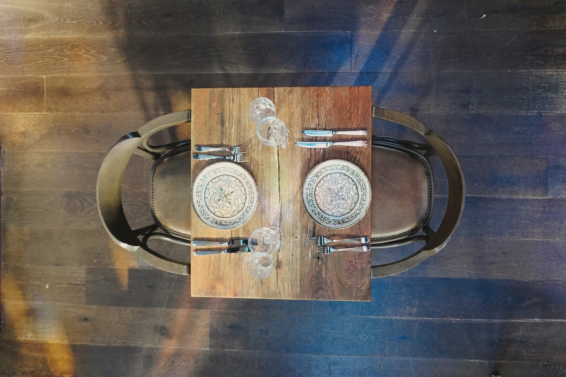 Patterned crockery arranged on a wooden dining table