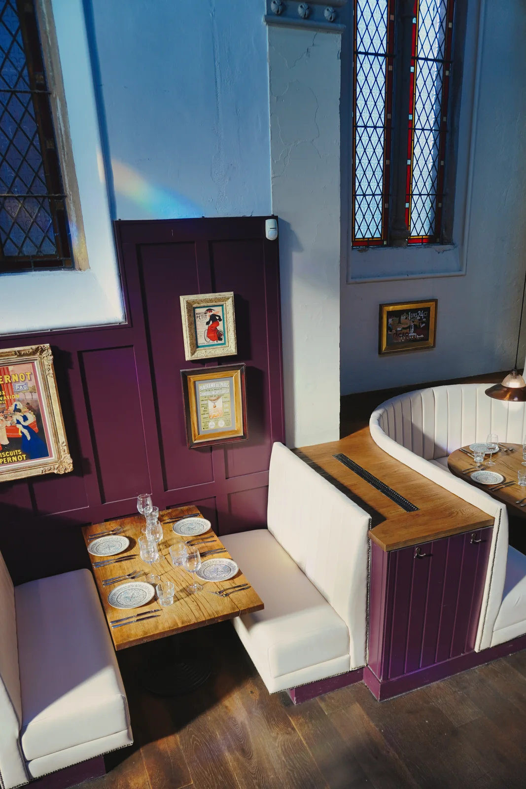 An intimate dining booth beneath stained glass