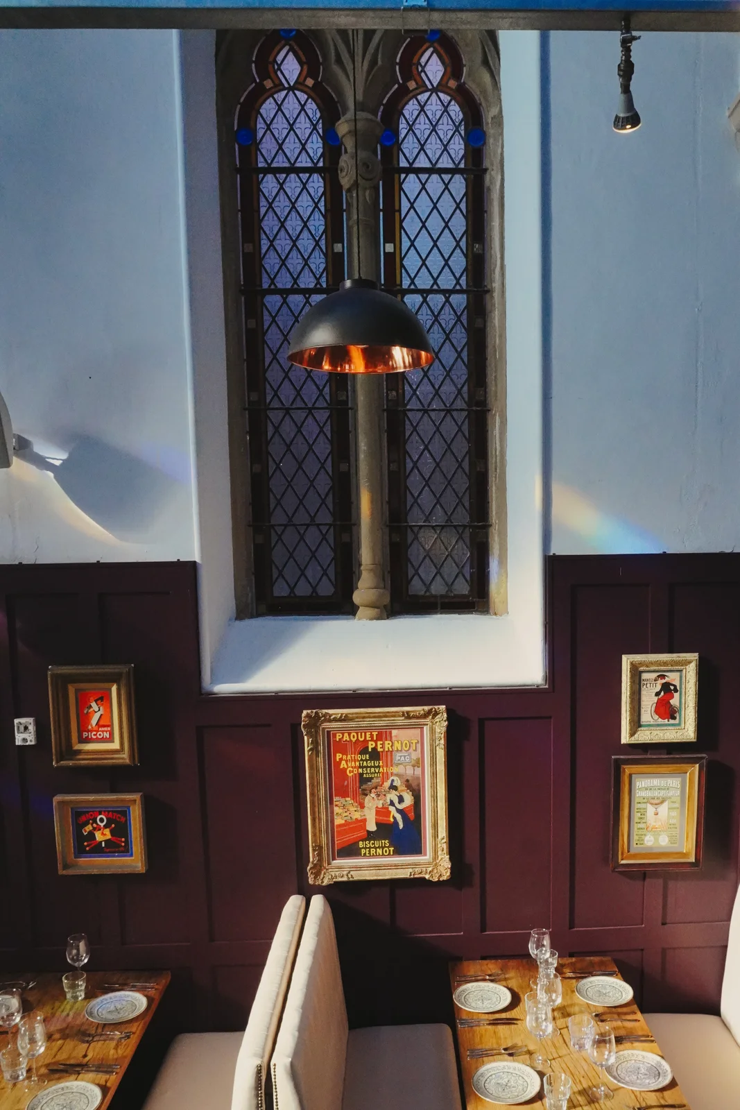 An intimate dining booth beneath stained glass