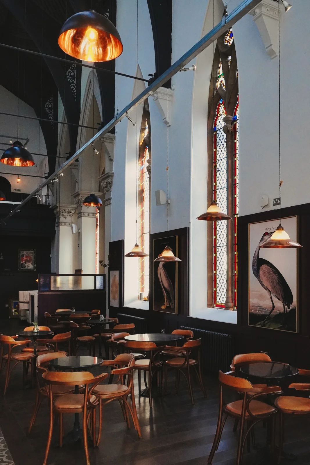 A dining table framed by tall church windows